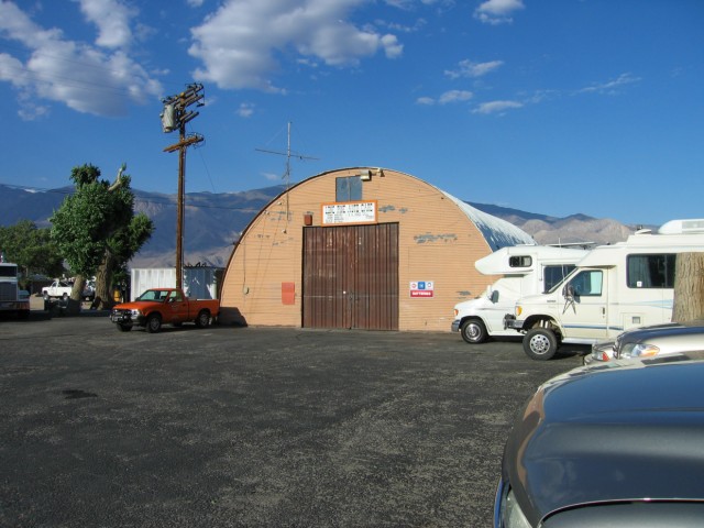 The garage at Miller's Towing is an old Quonset hut.  Out back they have a few car lifts and to the side they have a bunch of wrecked cars waiting to go to the scrap yard.